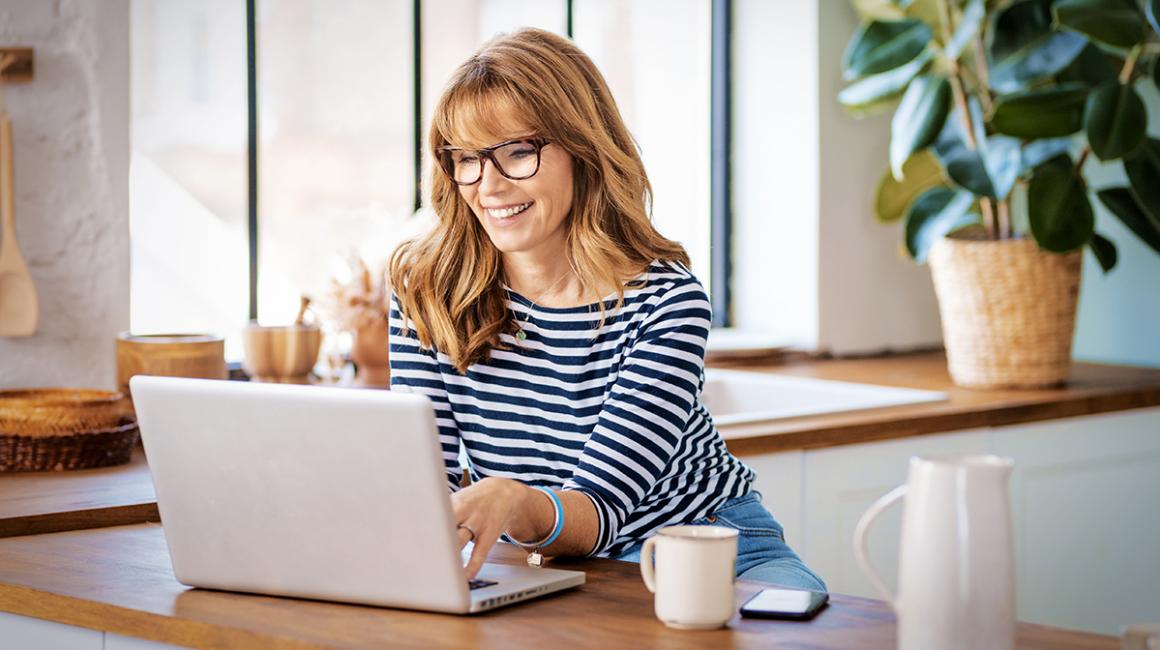 Kobieta w bluzce w paski przed komputerem 