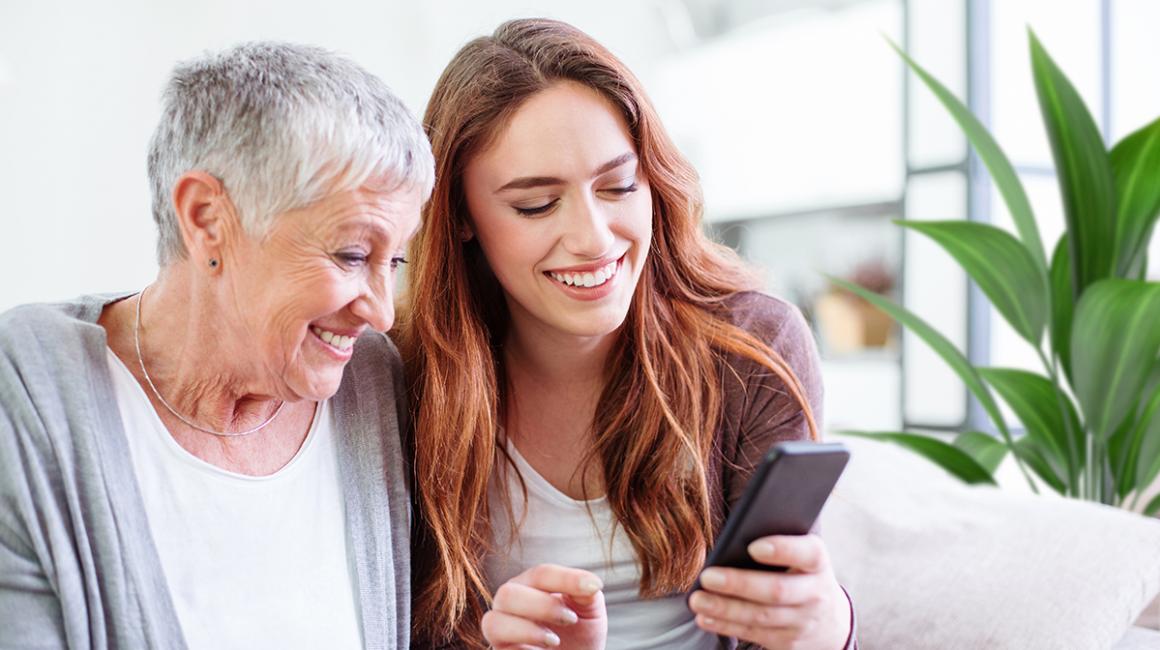 Wnuczka z babcią patrzą na komórkę