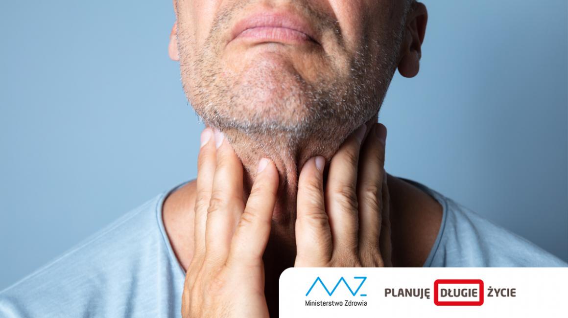 Mężczyzna dotyka palcami szyi. Na twarzy na grymas bólu. 