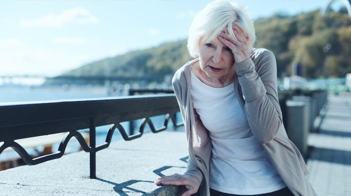 Starsza pani trzyma się za głowę