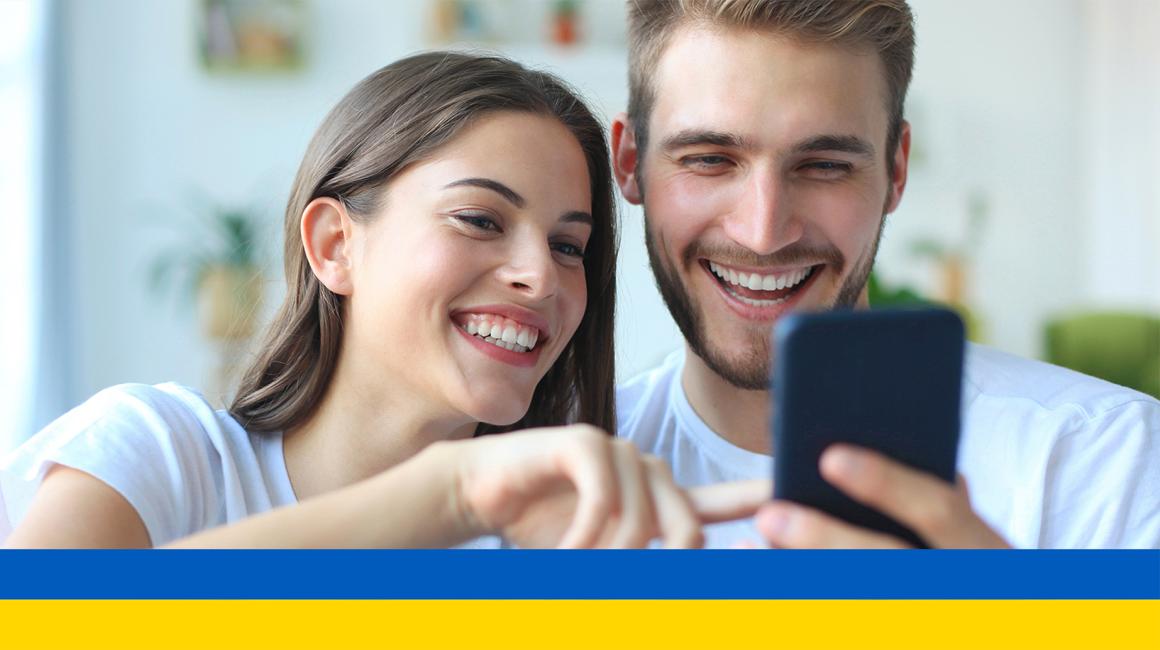 młoda para patrzy na komórkę, którą trzyma chłopak ukr