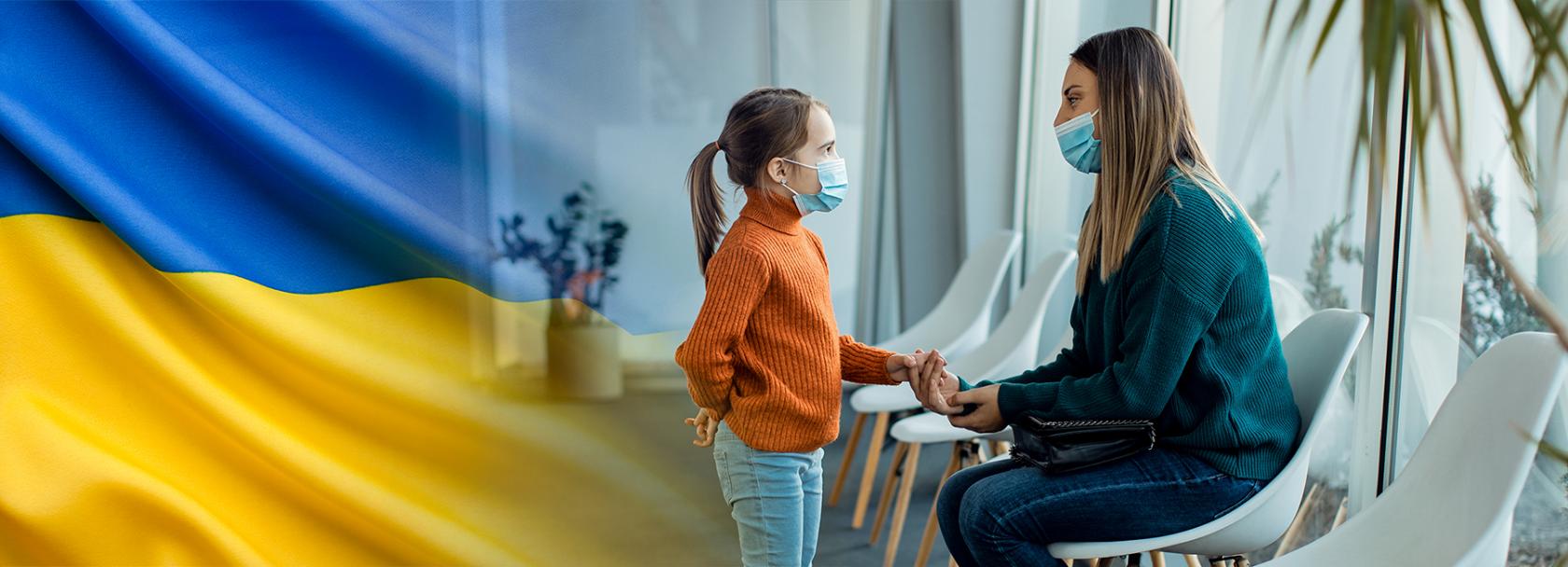 Matka z dzieckiem w przychodni, w lewym rogu ukraińska flaga
