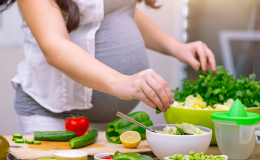 kobieta w ciąży gotuje.
